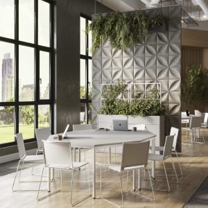 Modern collaborative workspace with white tables, ergonomic chairs, large windows, and lush greenery for a productive and stylish office environment.